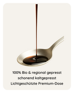 Bio Schwarzkümmelöl tropft auf Löffel – 100 % Bio, kaltgepresst, lichtgeschützte Premium-Dose